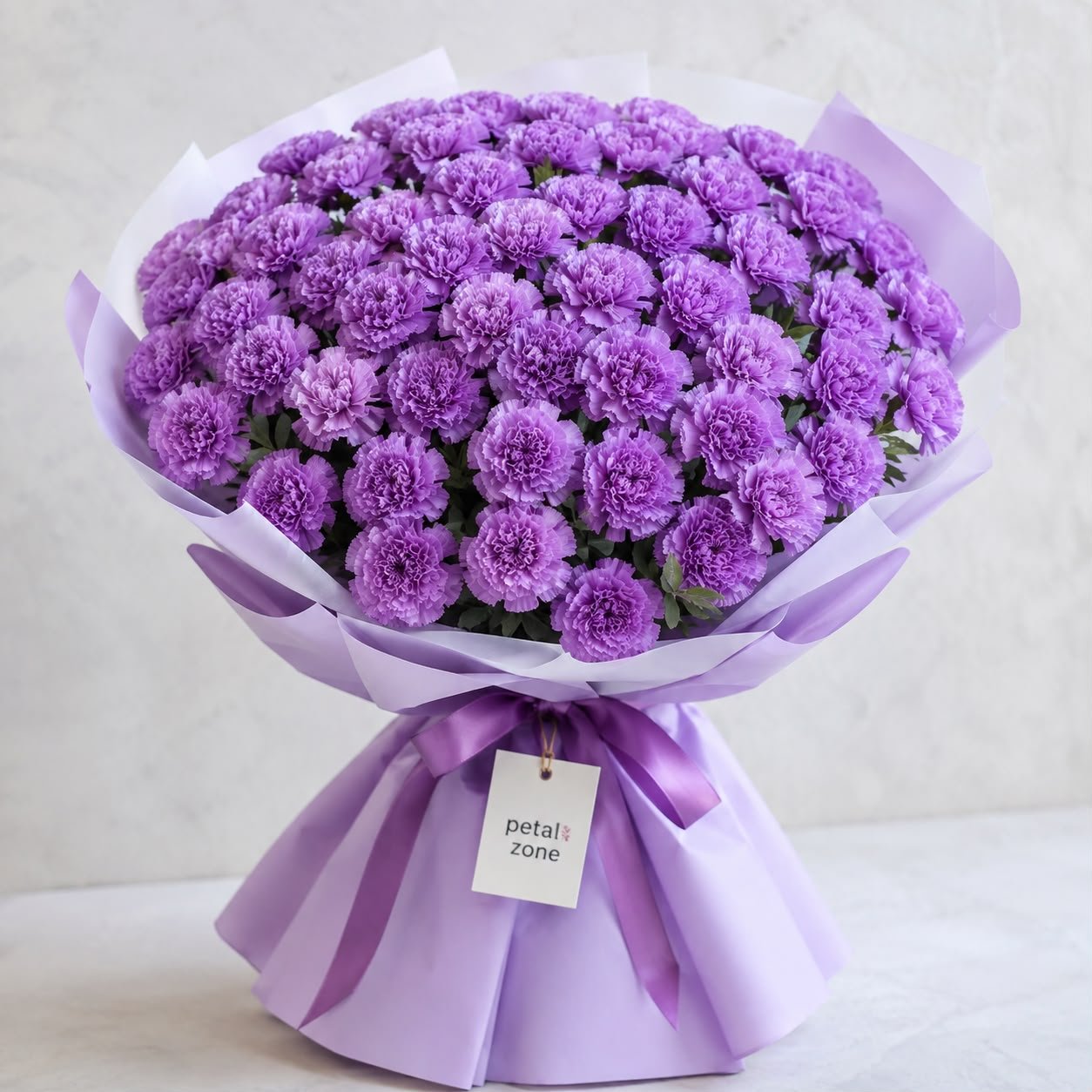 A Sea of Royal Blooms – 50 Purple Carnations Flat Bouquet